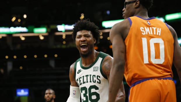 Dec 31, 2021; Boston, Massachusetts, USA; As he passes Phoenix Suns forward Jalen Smith (10), Boston Celtics guard Marcus Smart (36) cheers at teammate center Robert Williams III (44) after he blocked a shot during the second half at TD Garden. Mandatory Credit: Winslow Townson-USA TODAY Sports